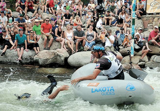 The crowd reacts as Masayuki Takahata, left, falls out of a raft and Todd Toledo reaches for him during a Teva Mountain Games Raft Cross event in Vail during the GoPro Games.